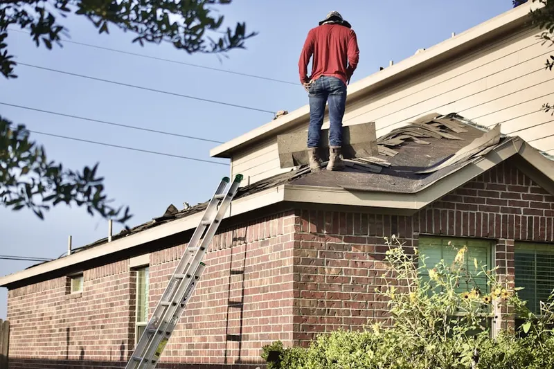 Professional roofer working on a residential roof in Lanesville